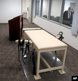 FILE - This Oct. 20, 2011 file photo shows the execution chamber at the Idaho Maximum Security Institution as Security Institution Warden Randy Blades look on in Boise, Idaho.