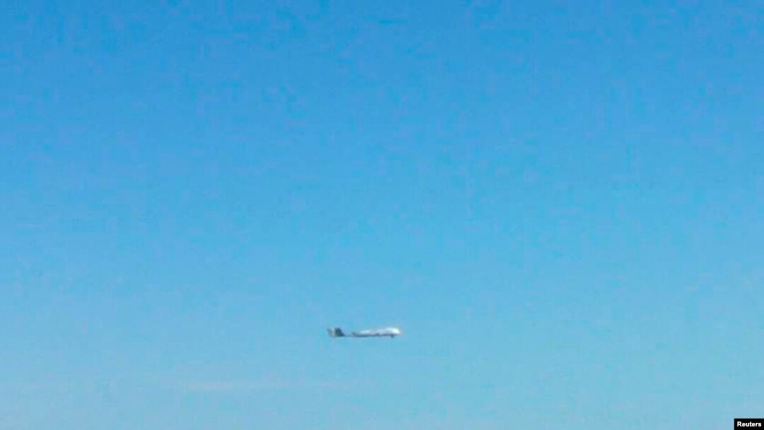FILE - An unidentified plane flies near disputed islands, called Senkaku in Japan and Diaoyu in China, in the air over the East China Sea, in this handout photo taken by Japan Air Self-Defence Force and released by Joint Staff of the Defence Ministry of J