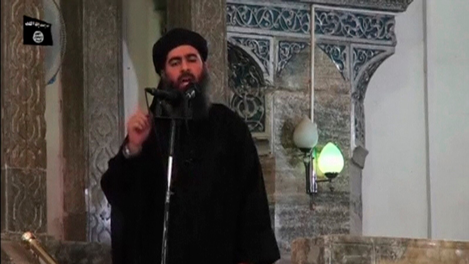 Image taken from recently released video shows man purported to be Abu Bakr al-Baghdadi, ISIL's reclusive leader, making what would be his first public appearance at a mosque in the center of Iraq's second city, Mosul July 5, 2014.