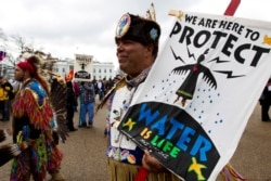American Indians and their supporters protest outside of the White House, Friday, March 10, 2017, in Washington, to rally against the construction of the disputed Dakota Access oil pipeline.