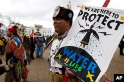 American Indians and their supporters protest outside of the White House, Friday, March 10, 2017, in Washington, to rally against the construction of the disputed Dakota Access oil pipeline.