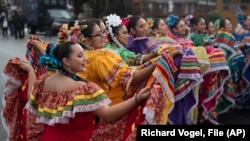 FILE - Members of the Cathedral City High School Ballet Folklorico pose for photo prior to joining in the Kingdom Day Parade in Los Angeles, Jan. 16, 2023.