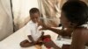 A mother hydrates her son who is stricken with cholera, at a clinic run by Doctors Without Borders in Port-au-Prince, Haiti, Friday, Nov. 11, 2022.