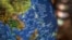 FILE - A globe shows the islands on the South China Sea with nine-dash line claims under Chinese territory on display at a bookstore in Beijing, July 13, 2018. 