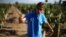 A man squeezes juice from grapes at a vineyard near Santiago, Chile, April 6, 2017.