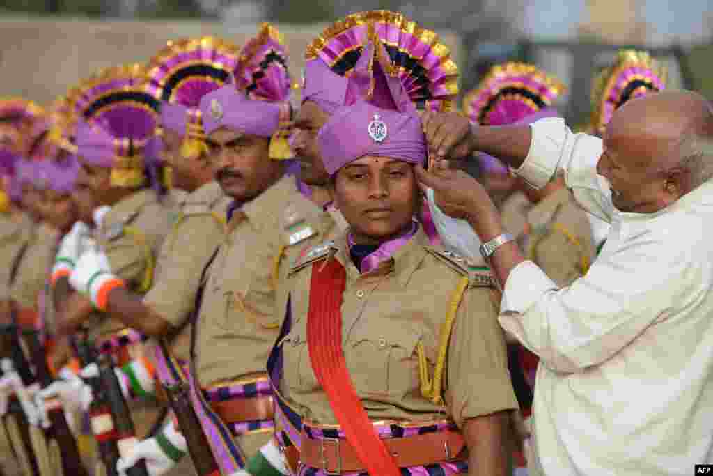 A member of the Andhra Pradesh State Police gets her headgear adjusted as she and others prepare for a full dress rehearsal for the Indian Republic Day parade in Secunderabad, the twin city of Hyderabad. India will celebrate its 65th Republic Day on Jan. 26. 