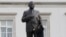 A worker cleans a statue depicting late Polish President Lech Kaczynski after it was installed at a central square in Warsaw, Poland, Nov. 7, 2018.
