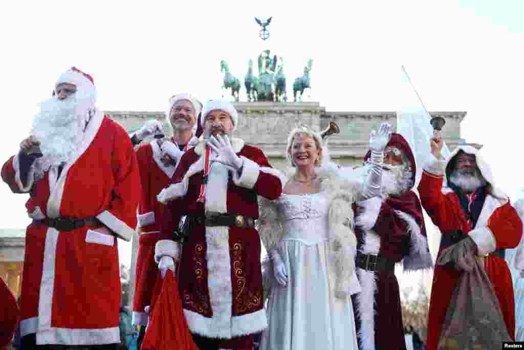 People dressed as Santa Claus and an angel attend the annual meeting of the rent-a-Santa Claus service, in Berlin, Germany.