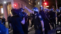 FILE - A police officer shouts at a video journalist in New York City, June 2, 2020, during demonstrations protesting the death in Minneapolis police custody of George Floyd.