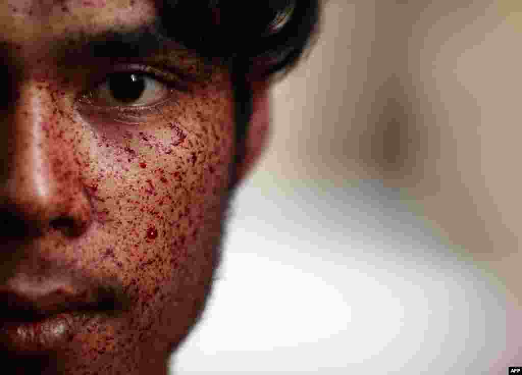 A Shi'ite Muslim man bleeds after flagellating himself during a ceremony for the Ashura festival at a mosque in central Yangon. (Soe Zeya Tun/Reuters)