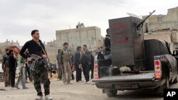 Members of the Free Syrian Army are seen deployed in al-Bayada, Homs, February 29, 2012.