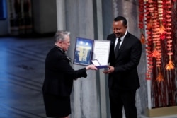 Ethiopian Prime Minister Abiy Ahmed Ali receives medal and diploma from Chair of the Nobel Comitteee Berit Reiss-Andersen during the Nobel Peace Prize awarding ceremony in Oslo City Hall, Norway, Dec. 10, 2019.