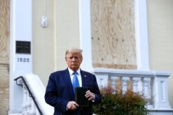 FILE - Then-President Donald Trump holds a Bible as he stands outside St. John's Church at Lafayette Park near the White House, June 1, 2020, in Washington.