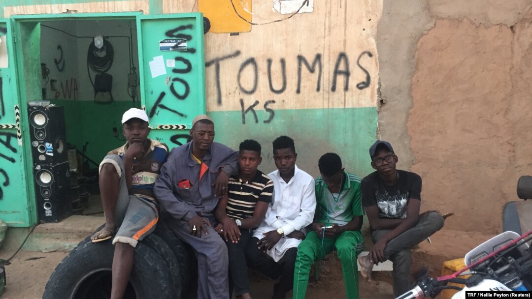 Abdoul Ahmed, second from left, is pictured outside his mechanic shop with his apprentices, Agadez, Niger, Feb. 20, 2018. 