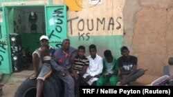 Abdoul Ahmed, second from left, is pictured outside his mechanic shop with his apprentices, Agadez, Niger, Feb. 20, 2018. 