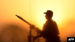 FILE - A Pakistani soldier stands guard during a search operation against militants on the outskirts of Peshawar, June 24, 2017. 