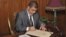 Egyptian President Mohamed Morsi signs a decree to put into effect the new constitution in Cairo December 25, 2012, in this handout photo released by Egyptian Presidency office.