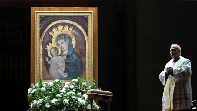 Cardinal Robert Francis Prevost, Prefect of the Dicastery for Bishops, leads the recitation of the Holy Rosary for Pope Francis' health in St Peter's Square at the Vatican, March 3, 2025.