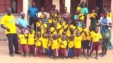 Mama Susan Tabia and some of the orphans under her care in front of the new facility just outside Adjumani town in northern Uganda. (S.P. Apiku/VOA)