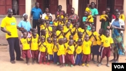 Mama Susan Tabia and some of the orphans under her care in front of the new facility just outside Adjumani town in northern Uganda. (S.P. Apiku/VOA)