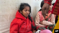 An injured girl reacts as she is being treated at a hospital after a stampede at the Maha Kumbh festival, in Prayagraj, India, Jan. 29, 2025