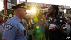 FILE - Minneapolis Police Chief Brian O'Hara talks with Michael Wilson on the third anniversary of George Floyd's death, May 25, 2023. A group of U.N. human rights experts formed after Floyd's death submitted a report about the U.S. criminal justice system on Oct. 5, 2023.