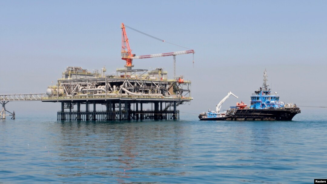 FILE - A ship is docked at a Al-Basra oil platform in the Middle East Gulf, Sept. 2014. 