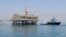 FILE - A ship is docked at a Al-Basra oil platform in the Middle East Gulf, Sept. 2014. 