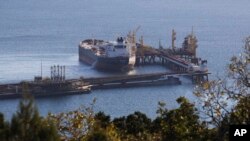 FILE: An oil tanker is moored at the Sheskharis complex, part of Chernomortransneft JSC, a subsidiary of Transneft PJSC, in Novorossiysk, Russia, Tuesday, Oct. 11, 2022. This is one of the largest facilities for oil and petroleum products in southern Russia.