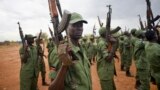 FILE - South Sudanese rebel soldiers raise their weapons at a military camp in the capital Juba, South Sudan.