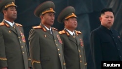 North Korean leader Kim Jong-un (R) stands with military officers in Pyongyang April 13, 2012. 