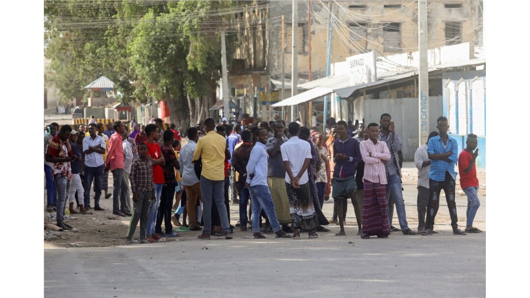 Somali people gather on the street during fighting between Somali government forces and opposition troops over delayed elections in Mogadishu, Somalia, Feb. 19, 2021.