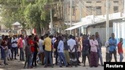 FILE - Somalis gather on a street during fighting between Somali government forces and opposition troops over delayed elections in Mogadishu, Somalia, Feb. 19, 2021. 