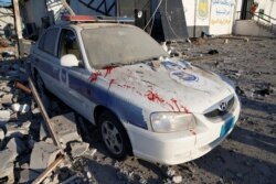 Blood stains are seen on a police car at a detention center for mainly African migrants, hit by an airstrike in the Tajoura suburb of Tripoli.