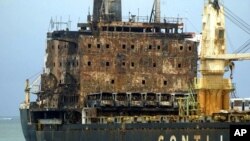 The MV Pacific Express which was set on fire by suspected Somali pirates on September 21, 2011 is towed along the Likoni channel by Kenya Ports Authority tug boats to the port of Mombasa, Kenya. (File Photo - September 30, 2011)