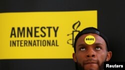 FILE - Human rights campaigner looks on during the release of an Amnesty International report in Abuja, Nigeria, May 16, 2017. 