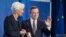 FILE - Outgoing European Central Bank President Mario Draghi waves next to his designated successor Christine Lagarde, at a ceremony marking the change of leadership at the ECB in Frankfurt, Germany, Oct. 28, 2019.