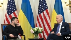 FILE - Ukrainian President Volodymyr Zelenskyy and U.S. President Joe Biden meet at the Intercontinental Hotel in Paris on June 7, 2024. The two leaders are expected to sign a defense and security agreement on June 13.