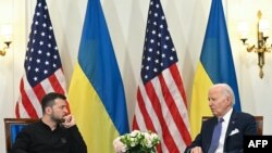 US President Joe Biden (R) and Ukraine’s President Volodymyr Zelensky (L) hold a bilateral meeting at the Intercontinental Hotel in Paris, on June 7, 2024.