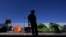 A migrant from Honduras seeking asylum in the United States stands in front of rows of tents at the border crossing, Monday, March 1, 2021, in Tijuana, Mexico. 