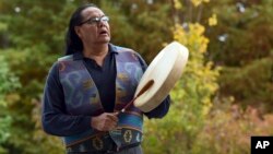 Dennis Zotigh poses outside the National Museum of the American Indian in Washington, Nov. 3, 2017. Many tribes even have their own national anthems known as flag songs that focus on veterans. 