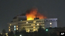 Smoke and flames light up the night from a blaze at the Intercontinental hotel after an attack on the hotel by Taliban fighters and a response by Afghan security forces backed by NATO helicopters in Kabul, June 29, 2011