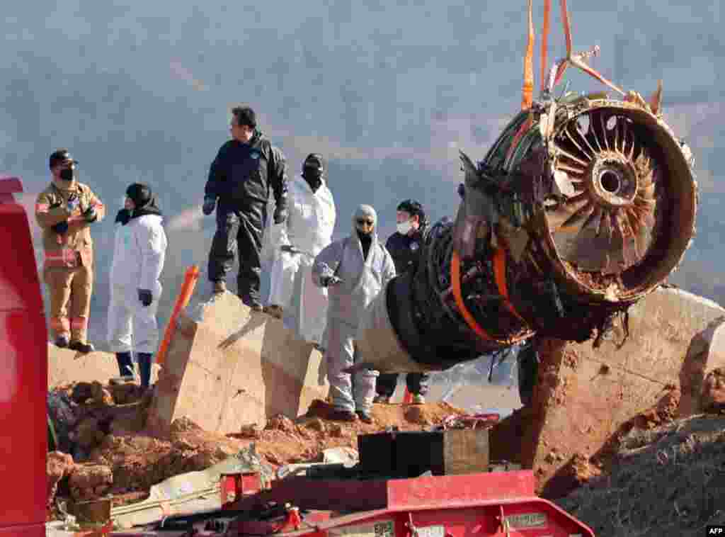 Teams salvage an engine of the Jeju Air Boeing 737-800 aircraft which crashed and burst into flames Dec. 29, 2024, killing nearly everyone onboard, at Muan International Airport, in Muan.