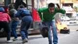 An Egyptian civilian runs out of a public bus after it was caught up in clashes between supporters of Egypt&#39;s deposed president Mohamed Morsi and police in the northeastern part of Cairo&#39;s Nasr City district. 