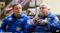 Russian cosmonaut Fyodor Yurchikhin, right, speaks as U.S. astronaut Jack Fischer listens during a news conference in Kazakhstan, April 19, 2017.