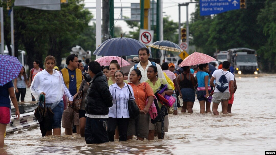 Stranded tourists salvaged belongings from submerged cars in the Mexican beach resort of Acapulco which had become a floodplain on Tuesday after some of the worst storm damage in decades killed more than 50 people across the country, Sept. 17, 2013. 