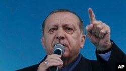 Turkey's President Recep Tayyip Erdogan gestures as he delivers his speech, during a rally for the upcoming referendum, in his hometown city of Rize, in the Black Sea region, Turkey, Monday, April 3, 2017.
