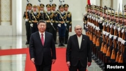 Chinese President Xi Jinping and Pakistani President Asif Ali Zardari walk past honor guards during the welcome ceremony at the Great Hall of the People in Beijing, China, Feb. 5, 2025.