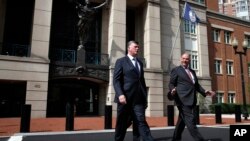 Kevin Downing, left, and Thomas Zehnle, with the defense team for Paul Manafort, leave federal court during the second day of jury deliberations in the trial of the former Trump campaign chairman, in Alexandria, Va., Aug. 17, 2018.