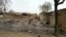 In this image shot with a mobile phone, a young girl stands amid the burned ruins of Baga, Nigeria, April 21, 2013.
